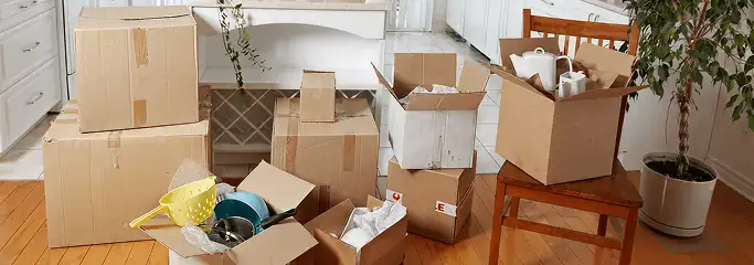 Packed moving boxes and household items in a kitchen before move-out or move-in cleaning, Arvada, CO.